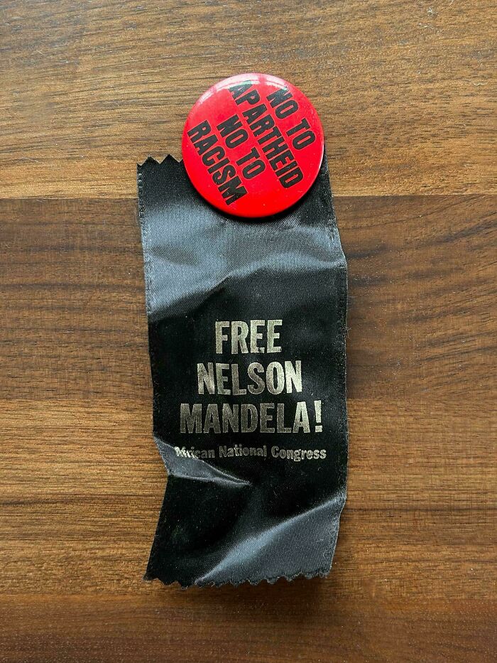 A Free Nelson Mandela ribbon and anti-apartheid pin, ephemera reflecting how the past has changed.