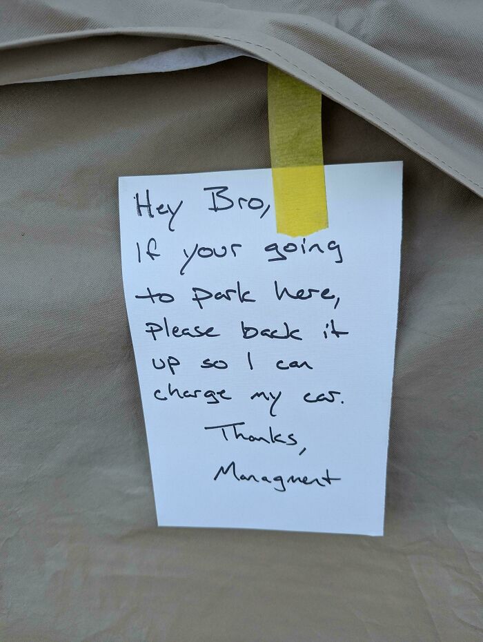 A note taped to a car asking the driver to back up, addressing a common sense parking issue.