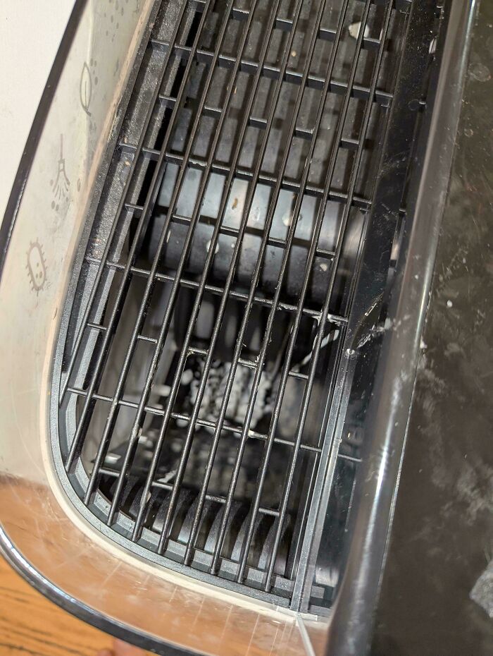 An air fryer filled with burnt residue, a frustrating cleanup for parents.