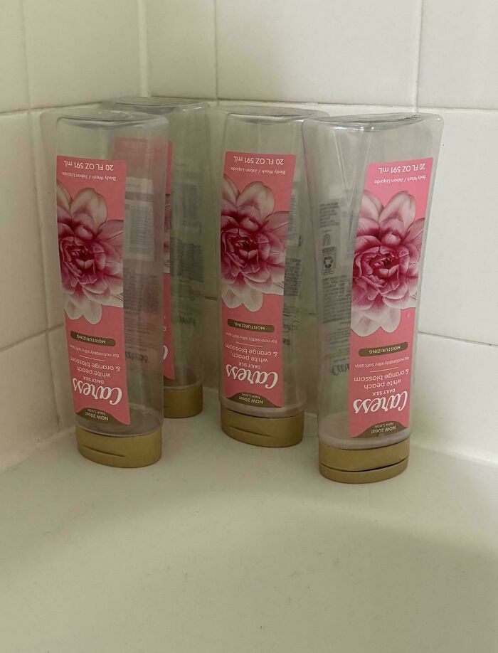 Five empty Caress body wash bottles, making becoming a cat lady look attractive.