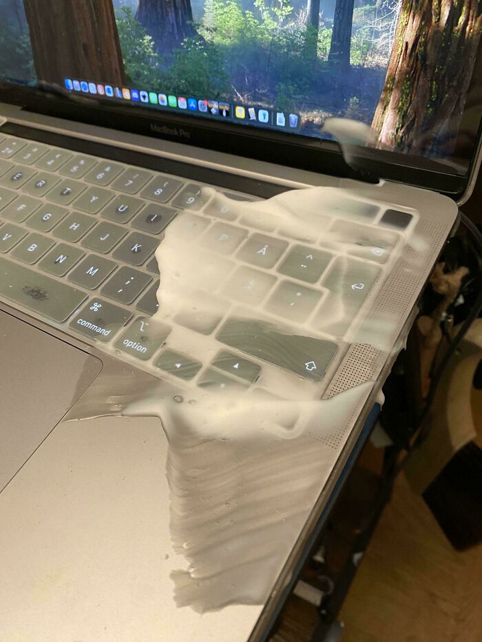 A MacBook Pro laptop covered in a white, foamy substance, making parents think: Why Did I Sign Up For This?