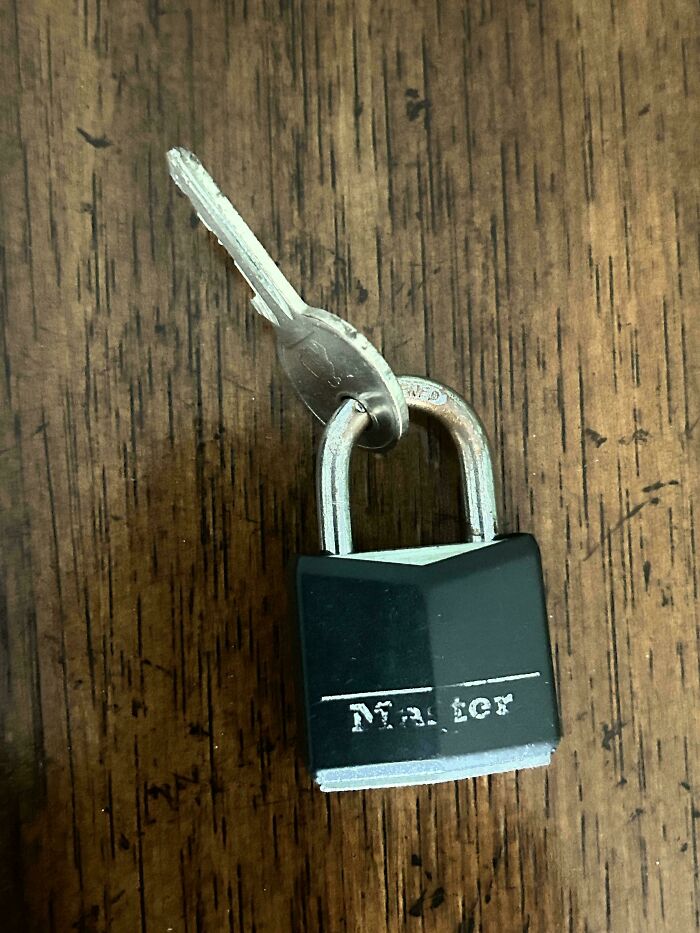A small black padlock with its key attached, symbolizing the difficulties parents can encounter.