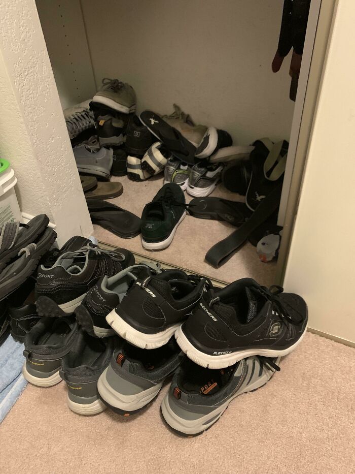 A messy shoe closet, showing a man in relationships and a cat lady. Various pairs of shoes are strewn across the floor and inside the closet.