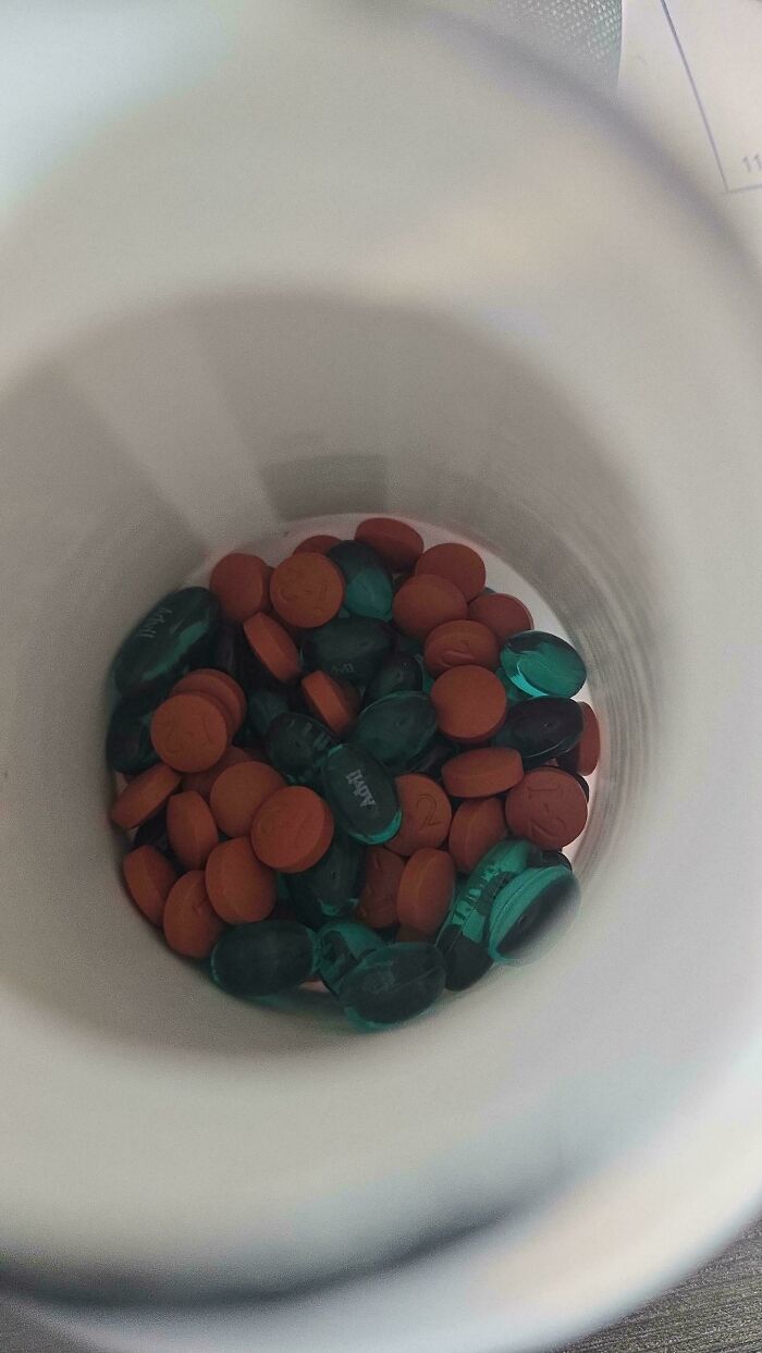 A container of various pills, reflecting why becoming a cat lady is more appealing.