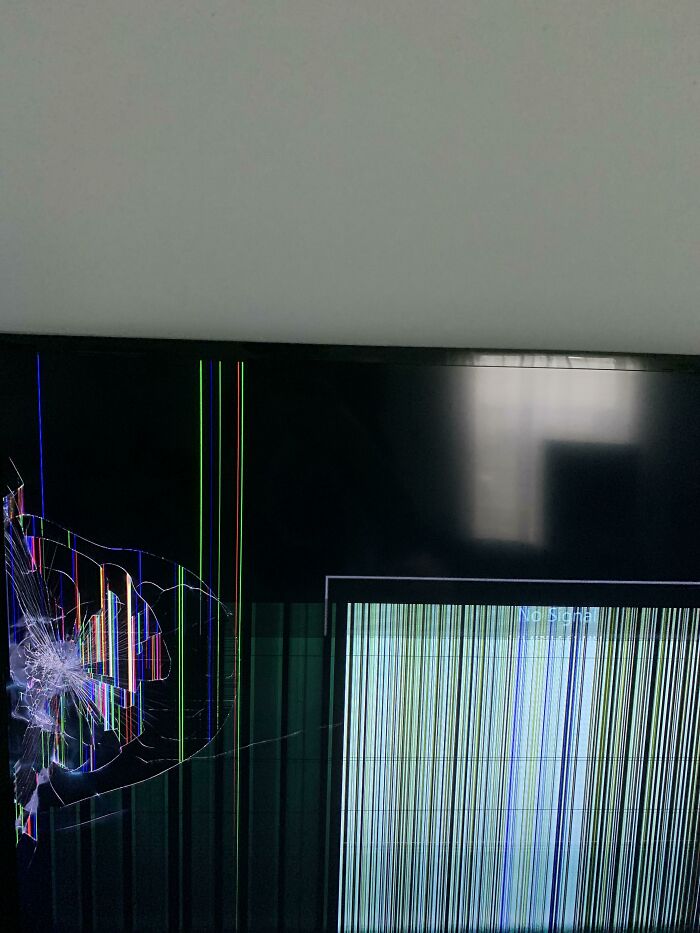 A cracked TV screen with colorful lines, showcasing the challenges parents face.