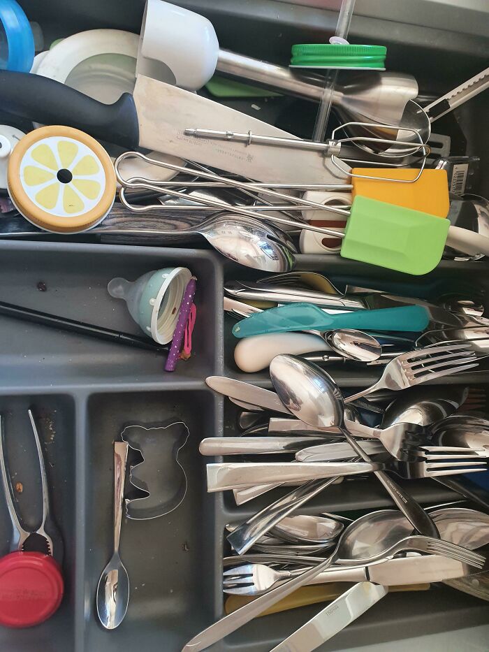 A messy drawer full of kitchen utensils, highlighting the struggles of men in relationships.