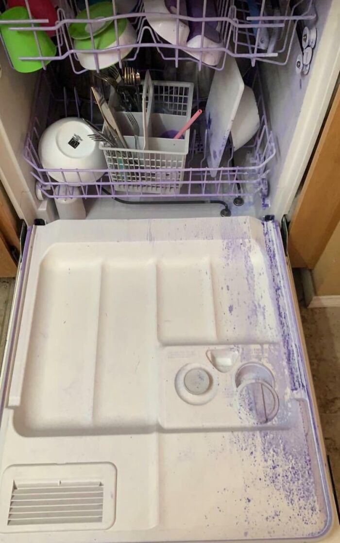 A dishwasher interior coated in purple residue, a perplexing problem for parents.