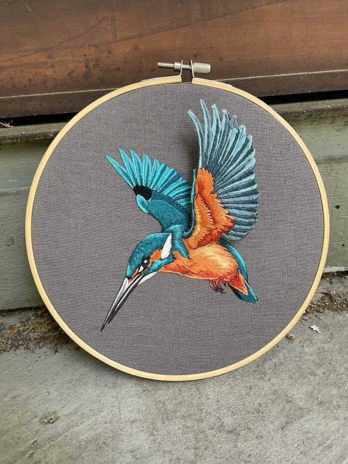 Colorful embroidery projects depicting a kingfisher bird in flight with orange and blue feathers