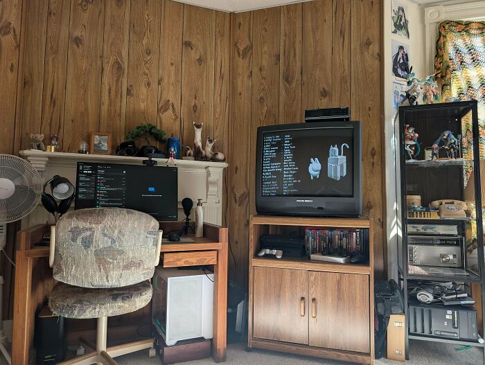 A retro-themed male living space with wood paneling, a desk setup, and an old TV, providing living inspiration.