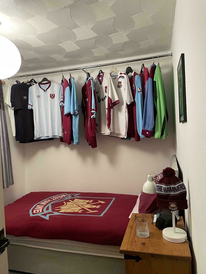 A male living space decorated with West Ham United football merchandise, including jerseys and a duvet cover.
