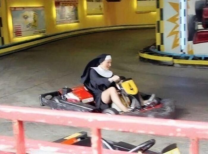 A nun playfully driving a go-kart on a track, a funny pic that people cannot forget.