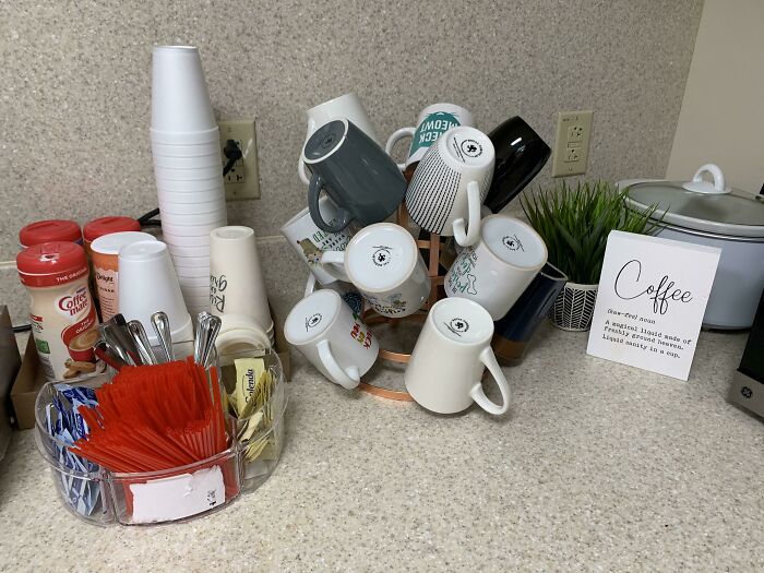 A countertop with reusable mugs next to disposable cups, showing a contrast in managing trash.