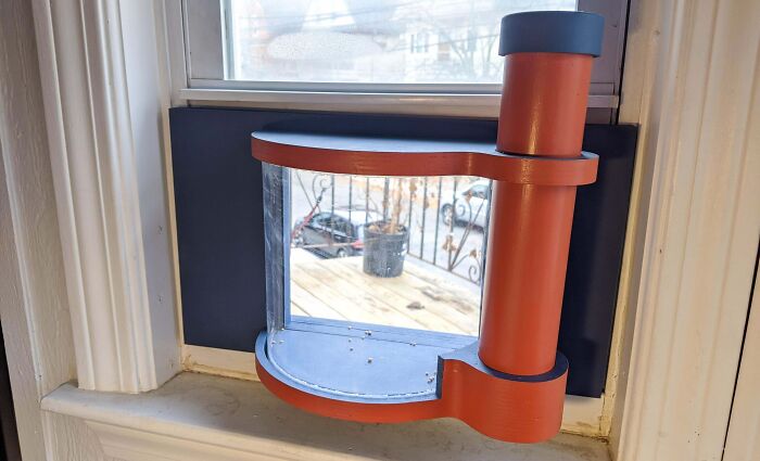A creative window feeder DIY home project, featuring an orange structure, perfect for transforming a space.