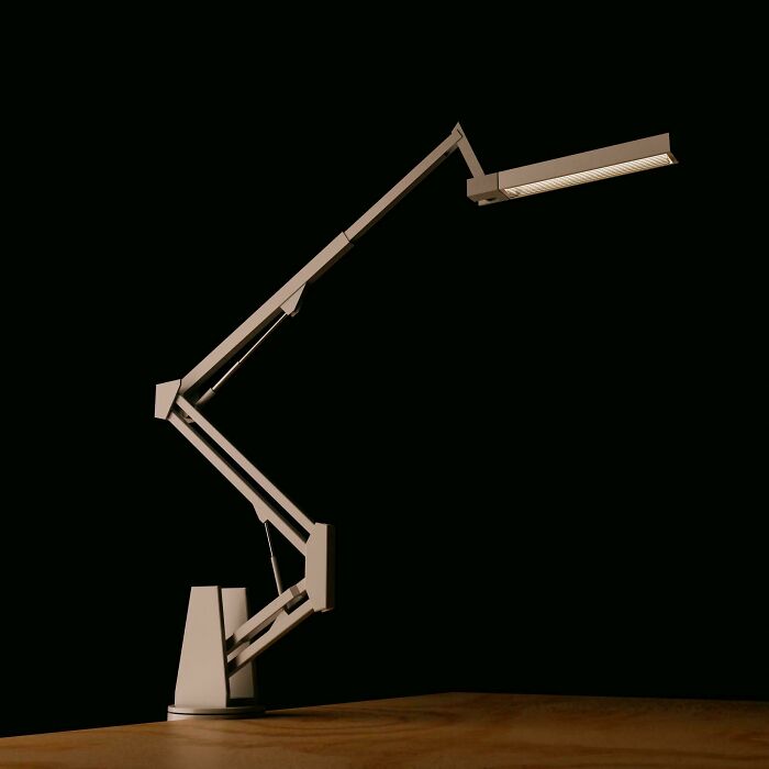 An elegant, articulated desk lamp, designed and possibly made with 3D printers, illuminating a dark space.
