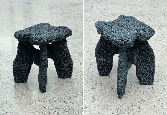 Textured dark gray 3D printed stool with an organic shape, viewed from two angles against a concrete floor.