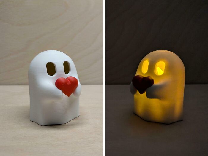 Two views of a cute ghost-shaped nightlight holding a red heart, made with brilliant 3D printers.
