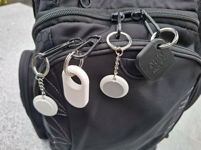 Various trackers attached to a backpack, including Eufy Security, showcasing brilliant items made with 3D printers.