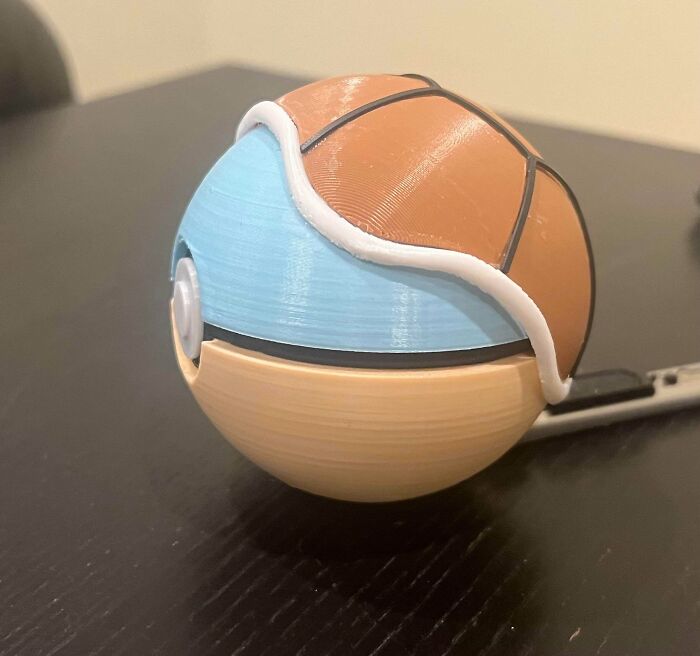A creative 3D printed Pokeball with an intricate design, showcasing brilliant things made with 3D printers.