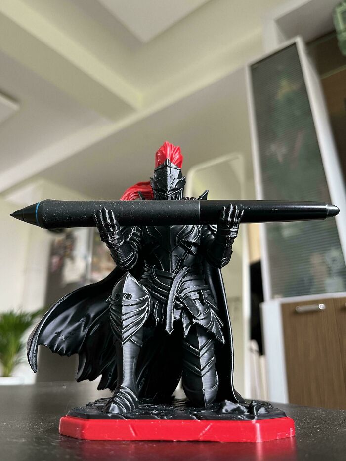 A detailed 3D printed knight figurine holding a digital drawing pen, designed for creativity.