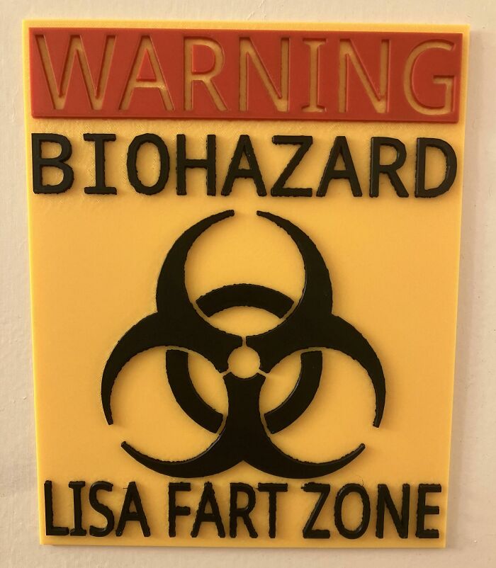 A yellow sign with black and red text warning BIOHAZARD LISA FART ZONE, a brilliant thing made with 3D printers.