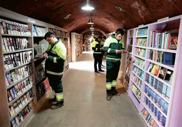 Workers in a tunnel bookshelf, a weird and wonderful world.