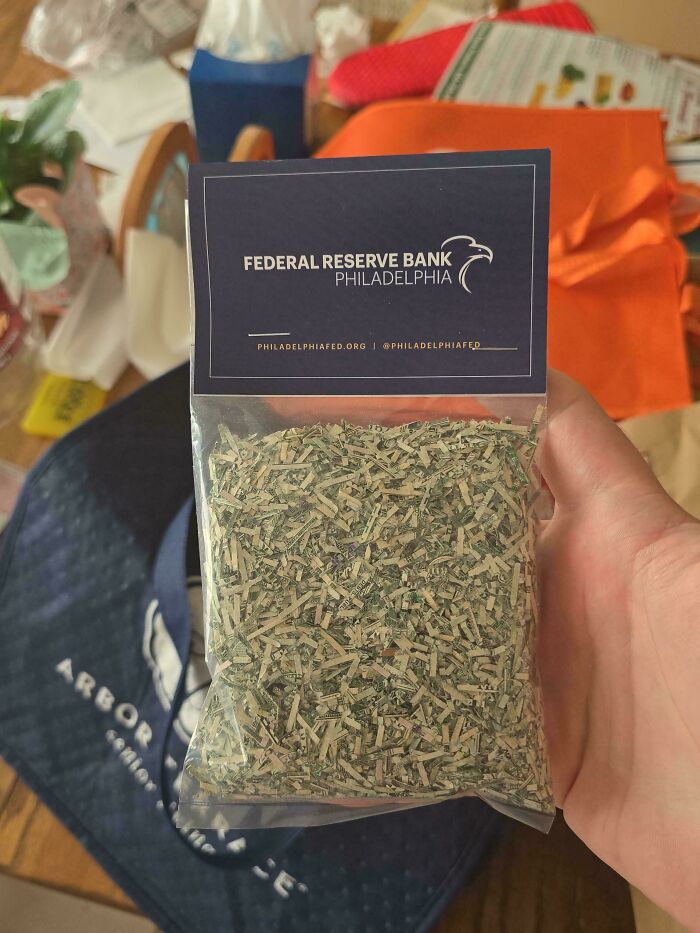 Wild pictures: A hand holding a bag of shredded currency from the Federal Reserve Bank Philadelphia, a weird and wonderful sight.