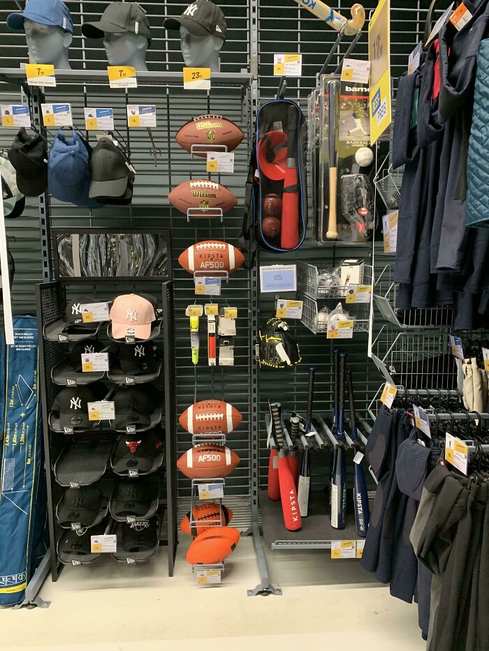 A sports store display with various weird and wonderful sports equipment, including baseball bats, gloves, and footballs.