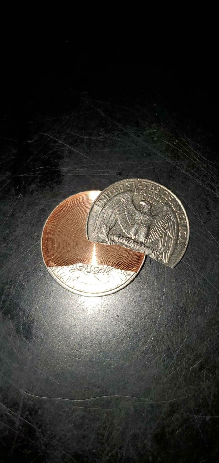 A modified US quarter with a copper spiral insert, a weird and wonderful example of coin artistry.