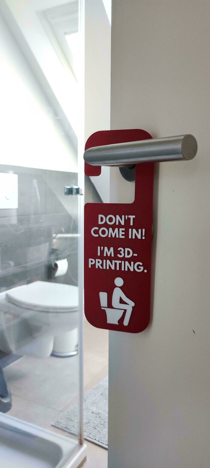 A funny bathroom door sign that reads Don't Come In! I'm 3D-Printing, a weird and wonderful everyday moment.