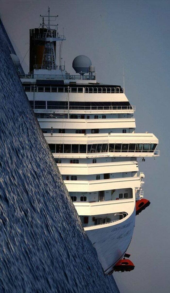 An optical illusion of a giant cruise ship appearing to emerge from a wild and wonderful ocean.