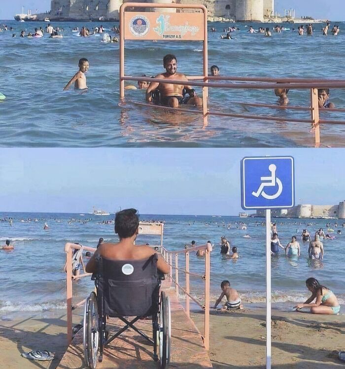 A man in a wheelchair on a ramp extending into the sea, a wonderful and inclusive beach experience.