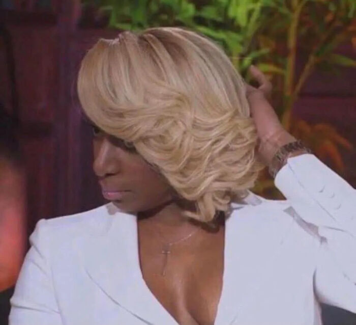 A woman looks distressed, touching her hair, symbolizing relationship red flags and mental health.