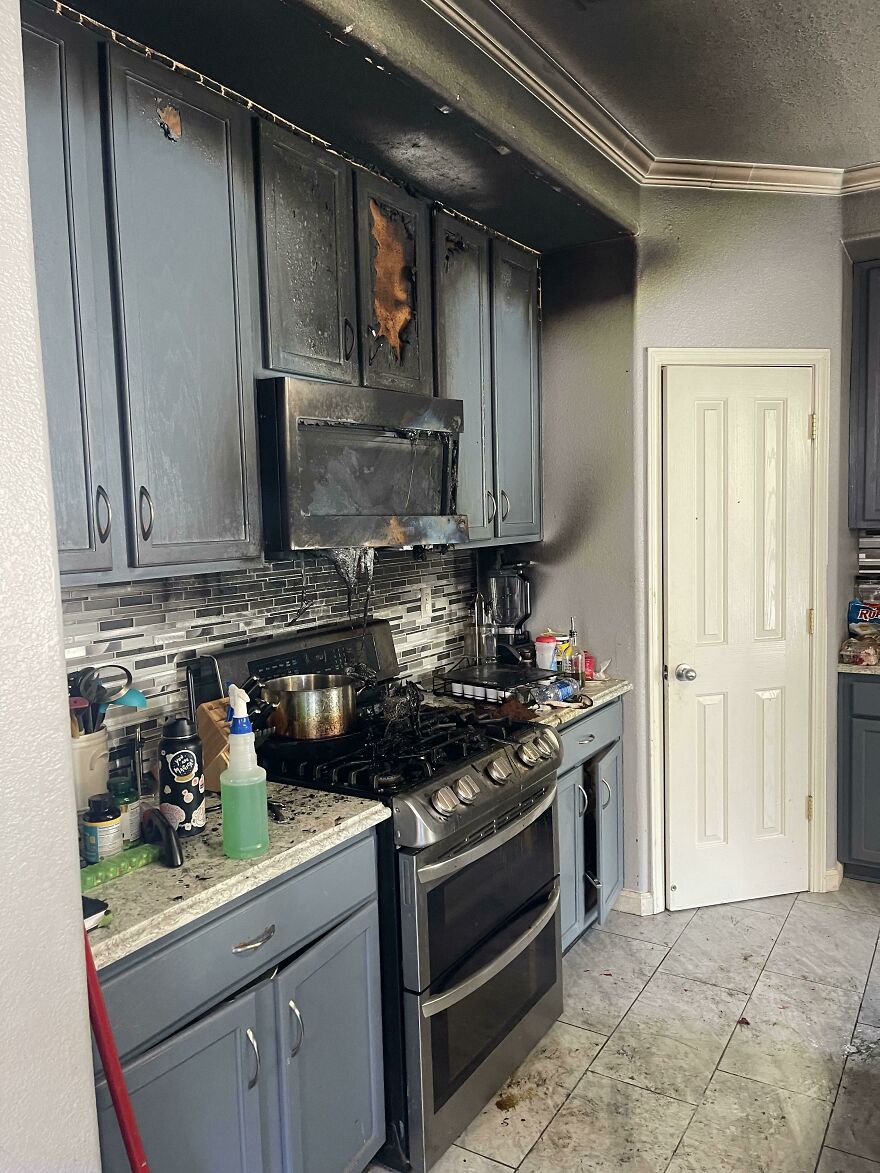A kitchen with cabinets and ceiling burnt from a fire, a funny regrettable fail.