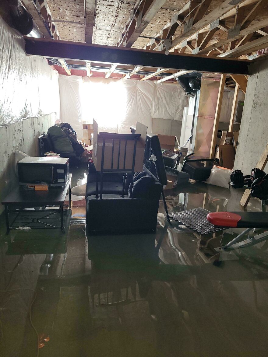 A flooded basement with furniture and boxes submerged in water, a funny regrettable fail.