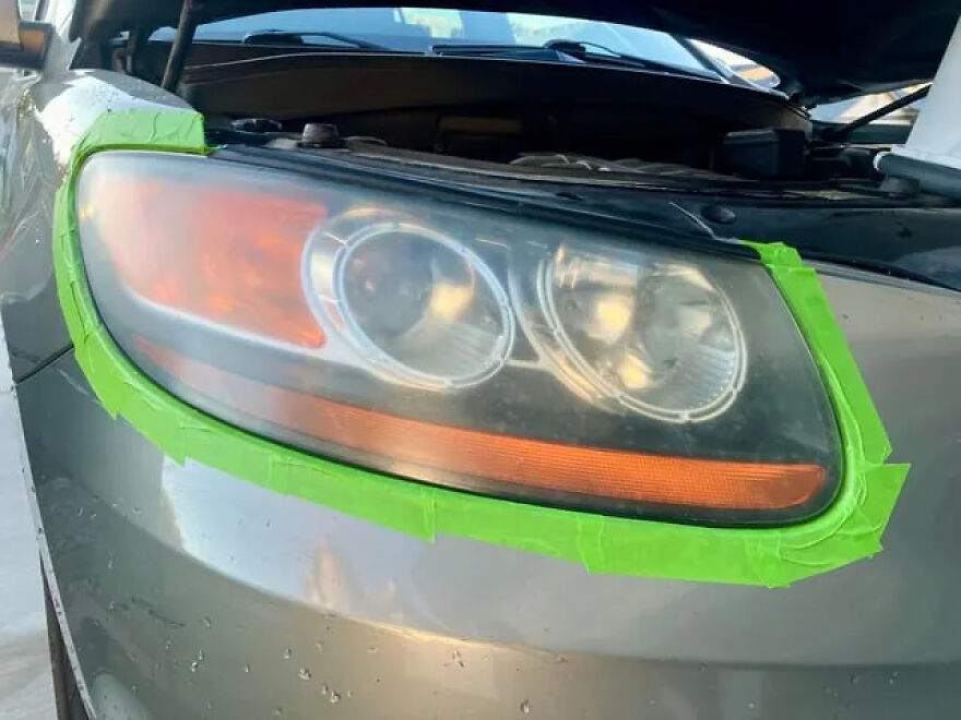 A car headlight taped for polishing, a common weird side hustle to make extra dough.