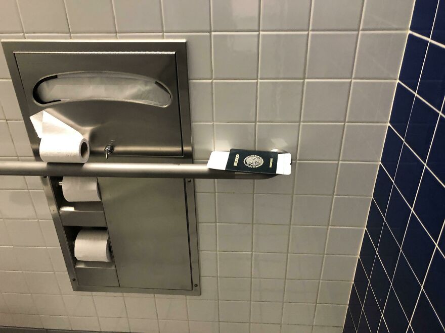 A passport left on a toilet paper dispenser, a funny unfortunate fail.
