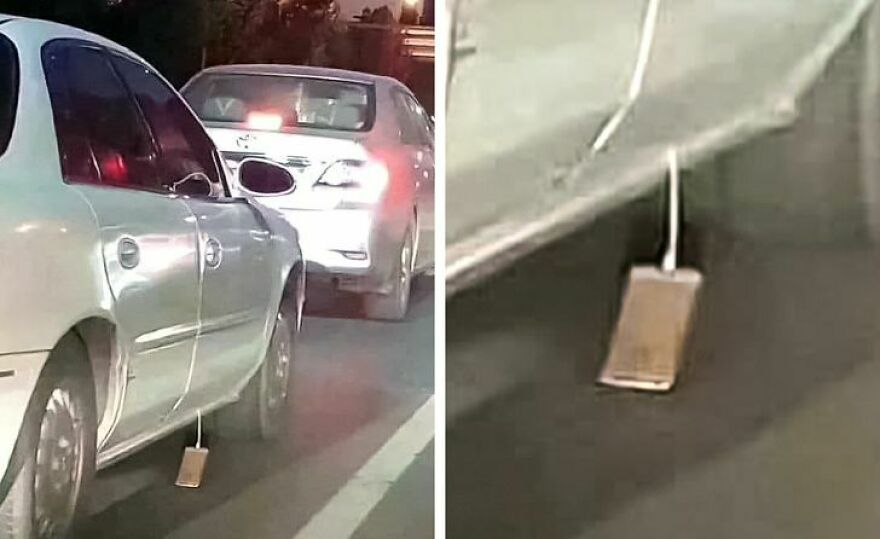 A smartphone dragging on the ground behind a car, a funny unfortunate fail.