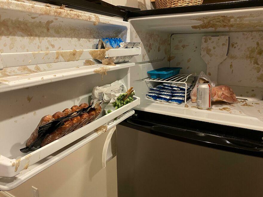A dirty fridge with food spills and packaged food. A funny unfortunate regret or fail moment.