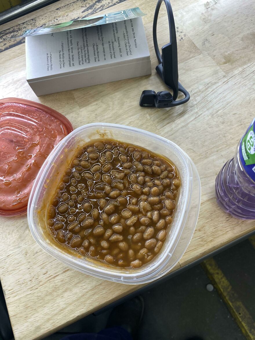 A plastic container filled with baked beans, a funny unfortunate regret.