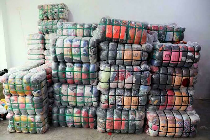 Large bales of compressed clothing, suggesting a weird side hustle for making extra dough.