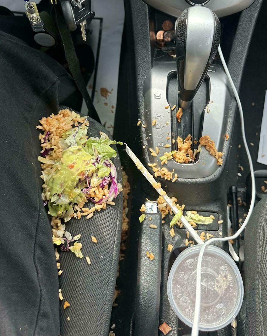 A car interior covered in spilled rice and salad, a funny unfortunate fail from a messy commute.