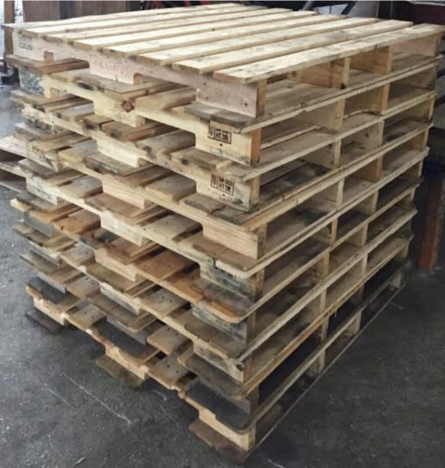 A stack of wooden pallets, often used in unusual side hustles for extra dough.