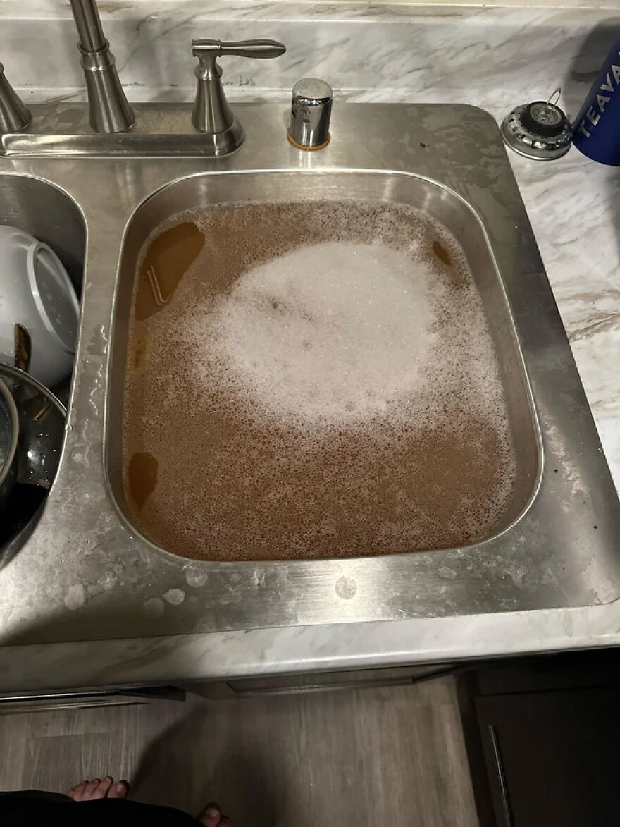 A kitchen sink filled with murky water, representing unexpected side hustles.