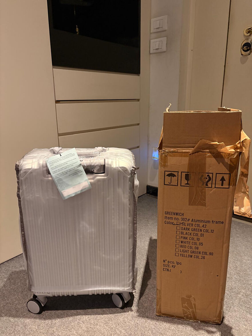 A white suitcase and a cardboard box, symbolizing a side hustle involving shipping or sales.
