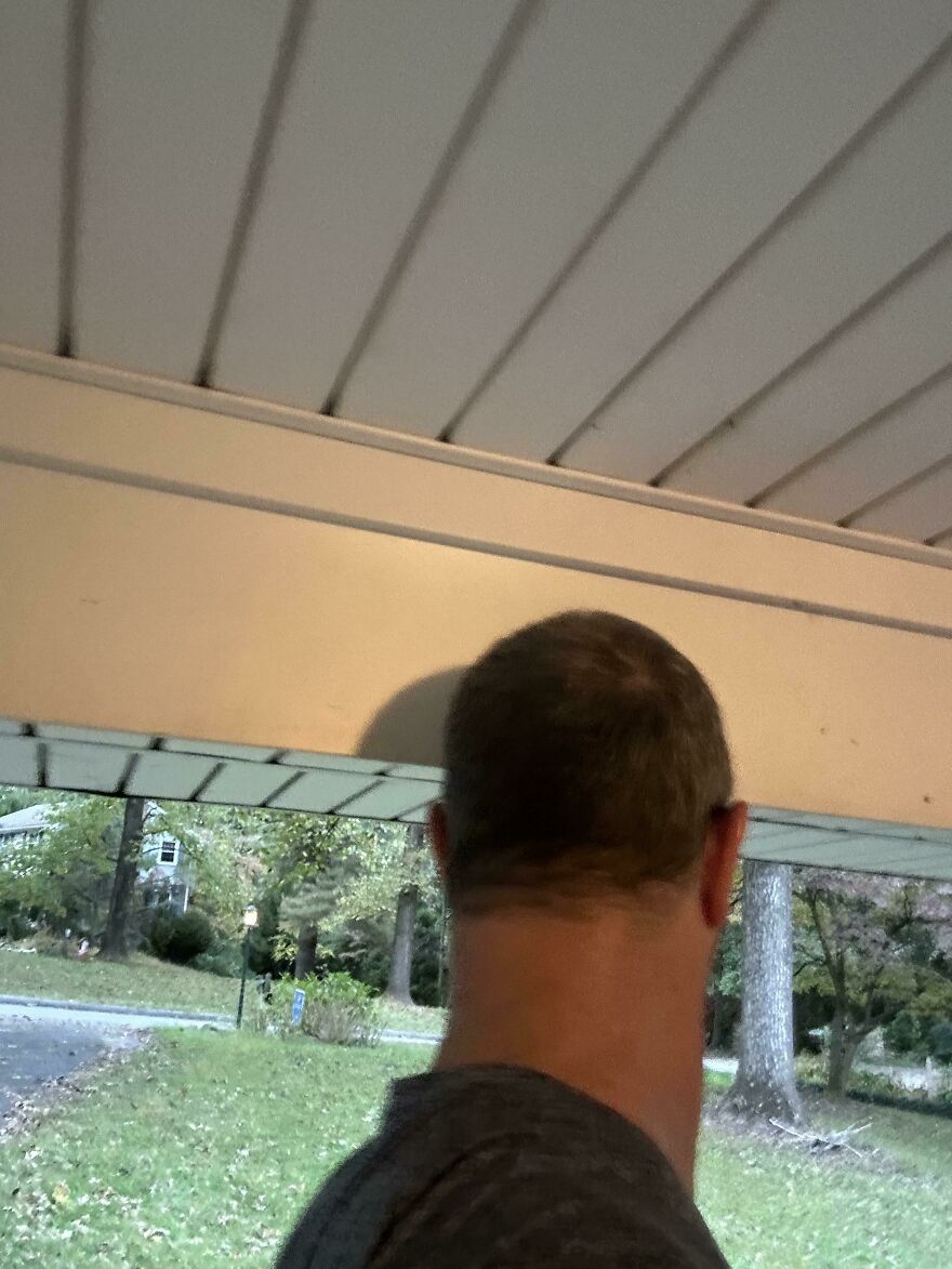 Funny unfortunate regret: the back of a man's head, showing an uneven, self-done haircut, a grooming fail.