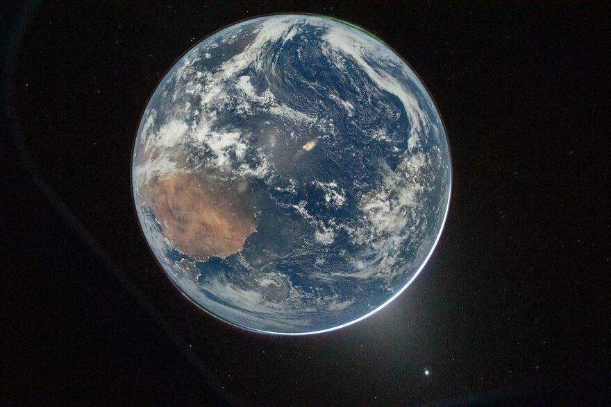 Full view of Earth from space, showing continents and clouds against the dark cosmos, an incredible sight.
