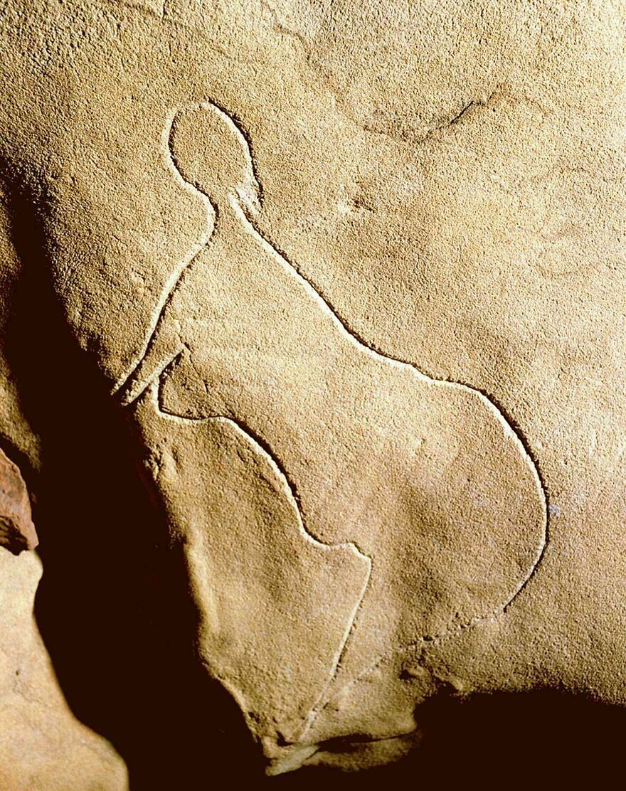 A cave carving of a human figure in profile, one of the many strange and incredible things happening on Earth.