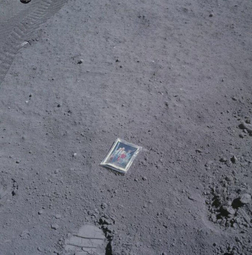 A photo of a family, lying on the lunar surface, one of many incredible things happening on Earth.