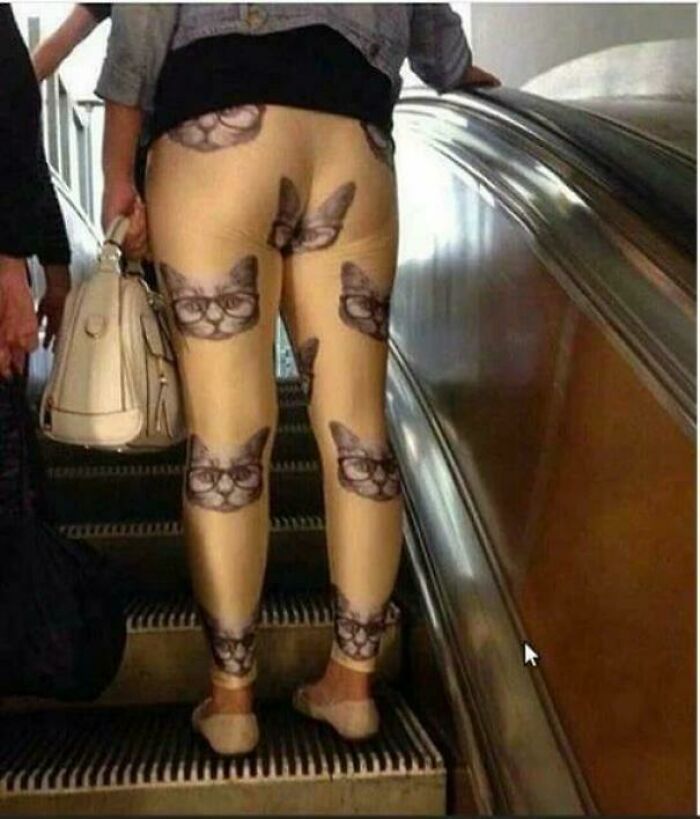 Person wearing leggings with cat faces wearing glasses, an amusing fashion crime outfit