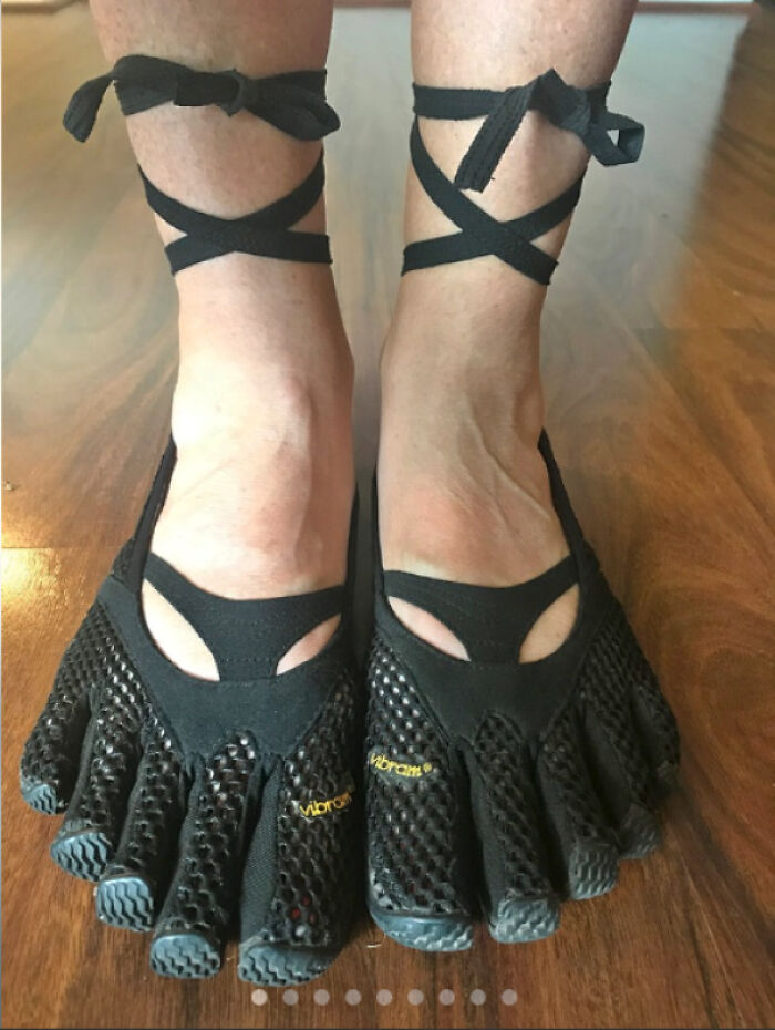 Feet wearing an extreme fashion crime: Vibram FiveFingers shoes with ballet-style ankle straps.